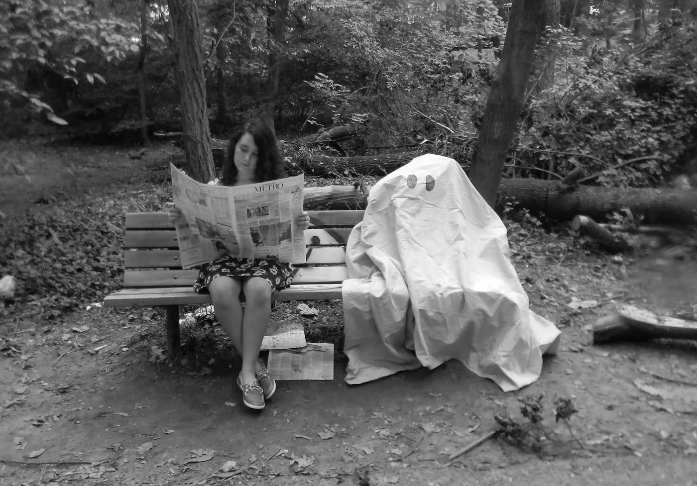 A picture of me in high school reading a newspaper next to a deflated sheet ghost. Unable to have anyone pose underneath the sheet with only two people and no tripod, we filled the ghost with sticks and branches found in the park around us. It didn’t really work, but we still got a laugh out of this photoshoot.